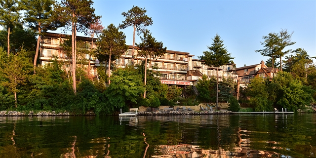 Cliffside Resort & Suites on the waterfront with a pier and chairs.