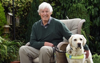 Gerry Woolfeden who lost life savings to a fraudulent investment firm, with his guide dog Philip