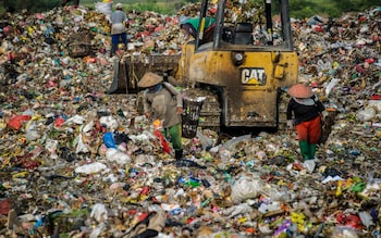 Scavengers collect valuable waste at Sidoarjo garbage dump in East Java, on June 5, 2018.