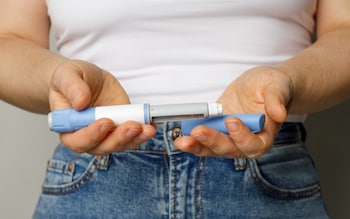 Woman with Ozempic pen