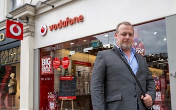 Image shows George Chesterton outside a phone shop