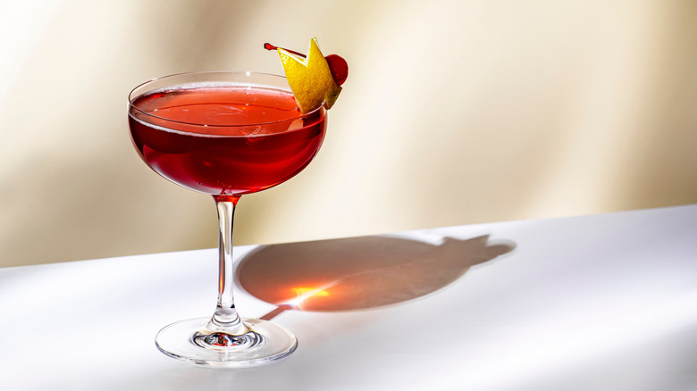 a cocktail with fruit garnishes