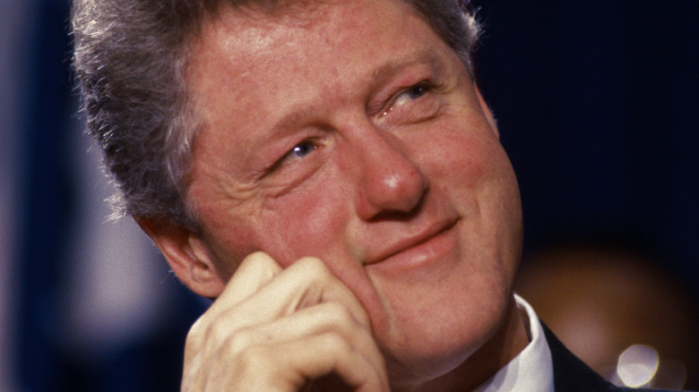 Bill Clinton with hand on face