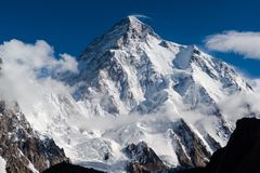 The snow-covered peak of K2 rising above the clouds