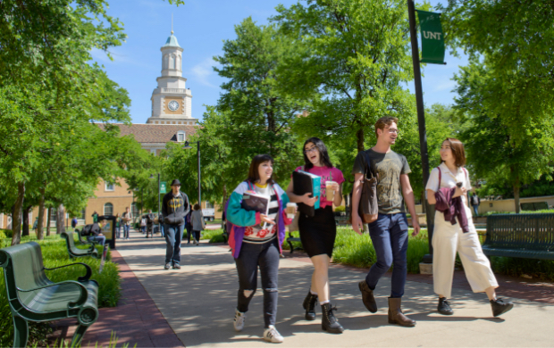 Student walking in the Library Mall on campus at UNT Denton