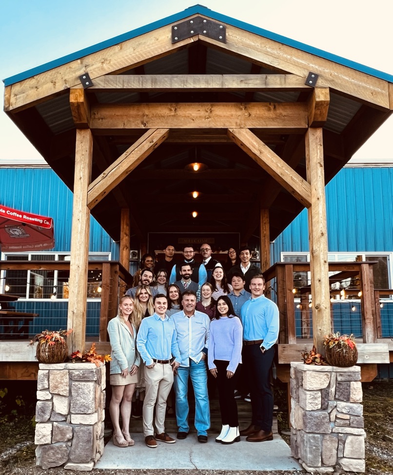 Tom Bartels stands with students after the BLOY student dinner at North Pole Coffee Roasting Co.