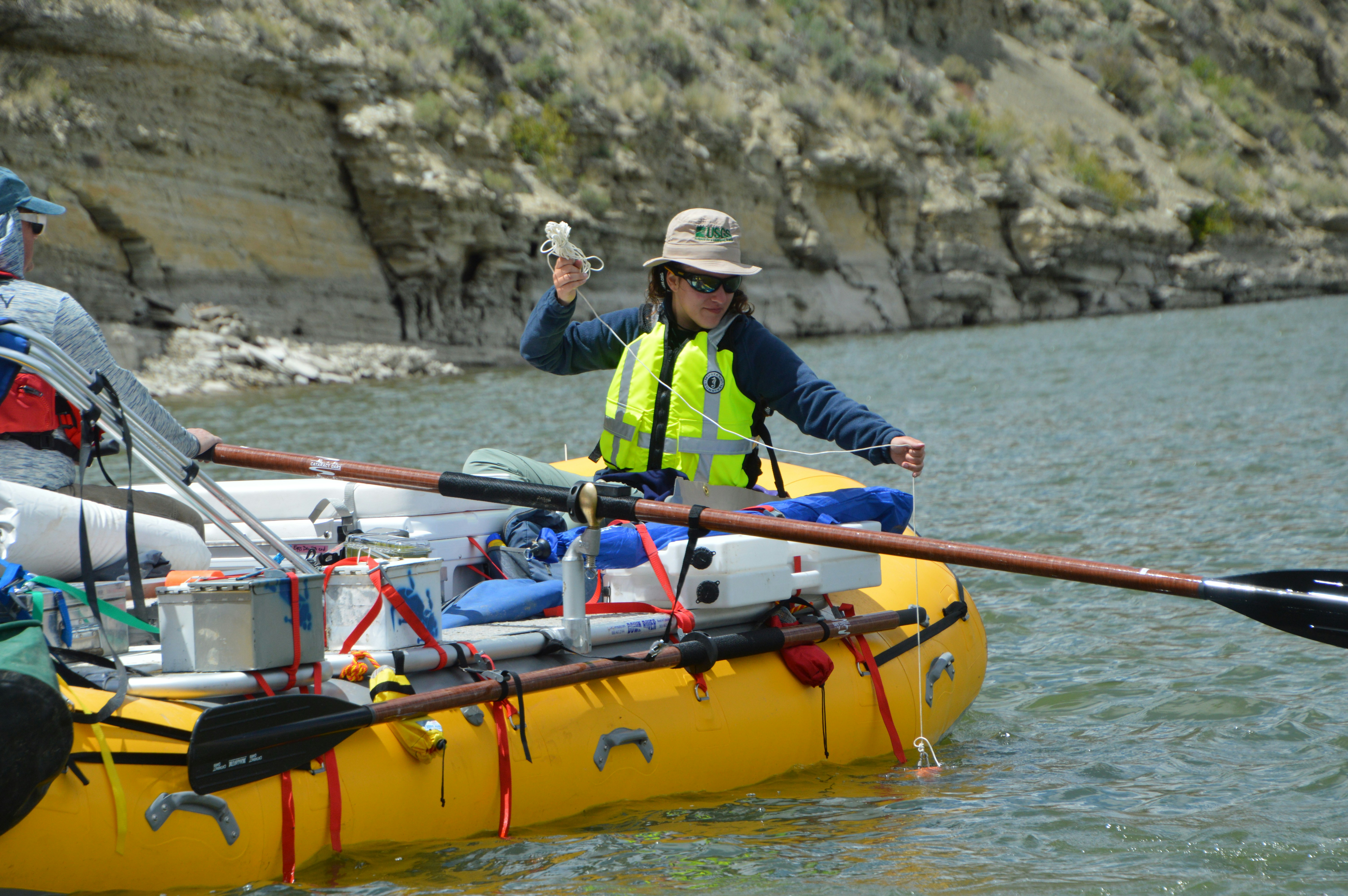 A researcher samples water quality in a river.