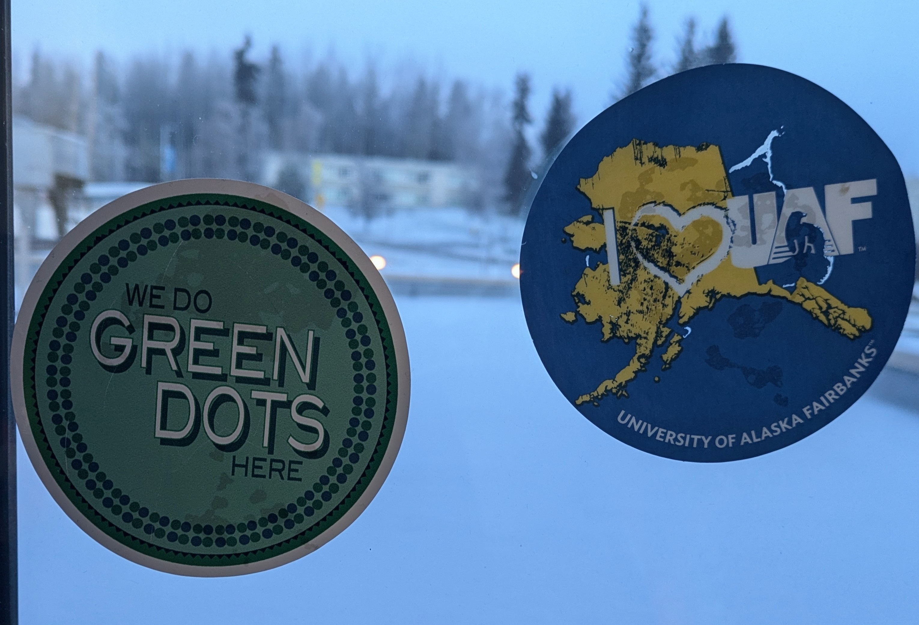 Green Dot window cling alongside a UAF window cling.