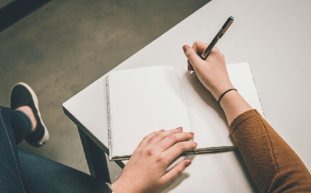 A student writing on paper