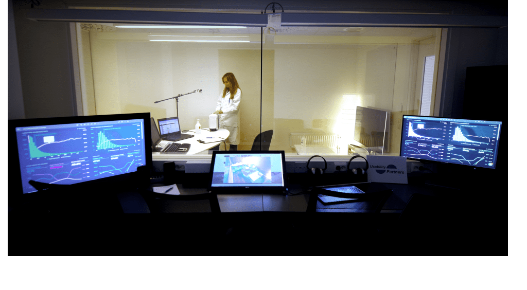 Person in lab coat in a usability lab