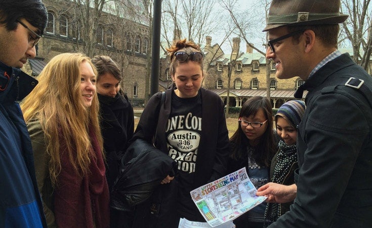 Shawn Micallef talking to a group of students on a walk.