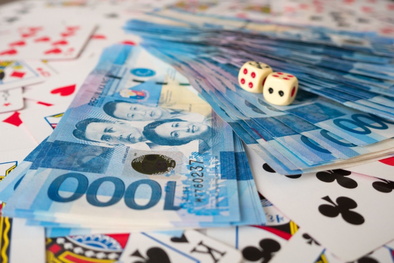 Philippines cash with dice and cards