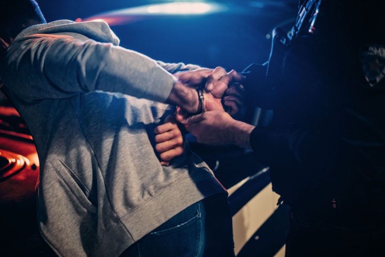 Police officer arresting man