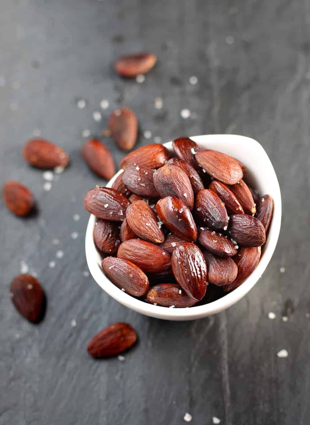 Smoked almonds in a dish with sea salt.