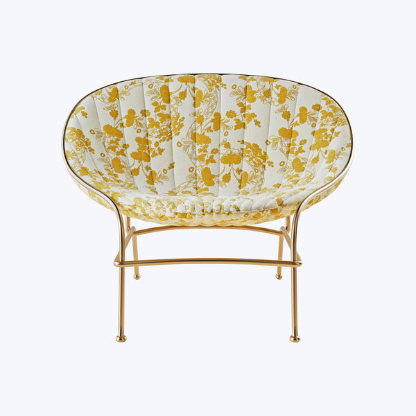 Modern golden chair with floral upholstery, sleek design for interiors.