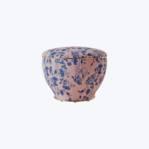 Traditional Asian-inspired floral patterned bowl on pinkish-beige background.