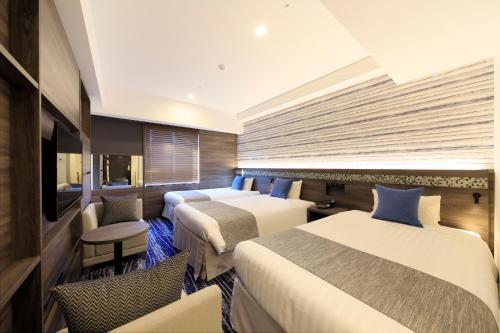 Quintessa Hotel Sapporo Susukino客房内的一张或多张床位