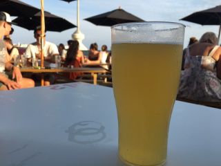 Checked in at Shelter Hall Raw. Having a beer on the beach — with Jessica