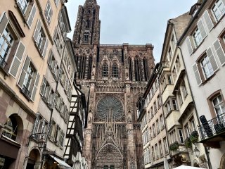 Looking down a street up at the towering ornate cathedral.