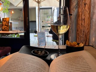 Checked in at Royal 26. Pairing a good book with a glass of Pinot Gris