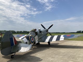 A beautiful World War Two fighter on a small airstrip on a nice Summer day.