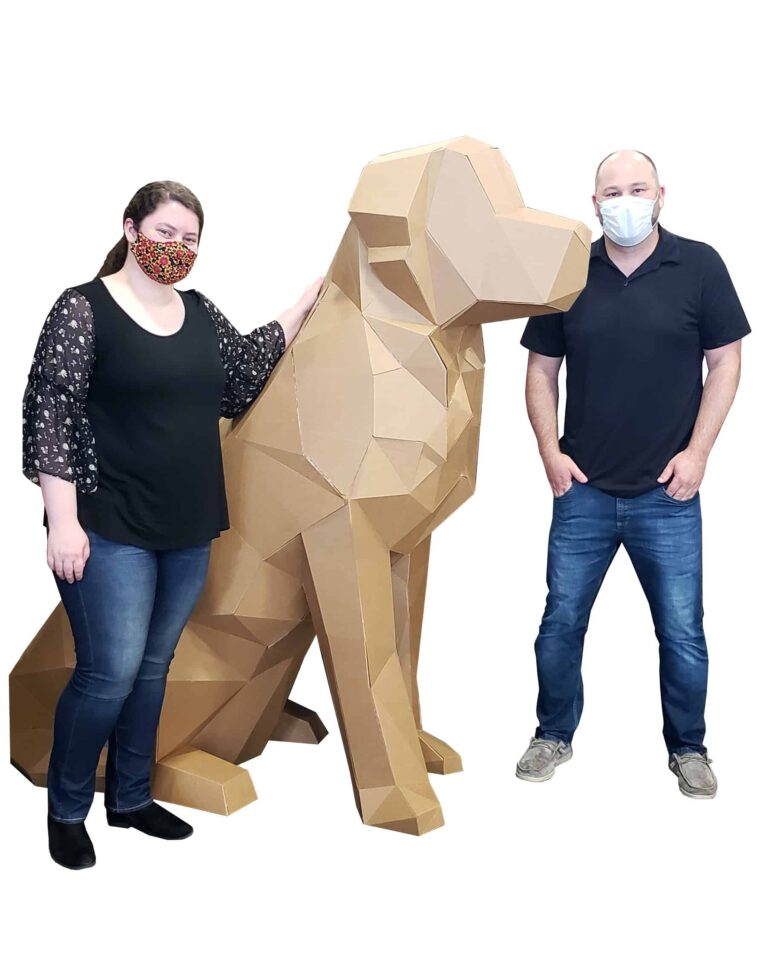 3d dog larger than a person made out of corrugated next to two people