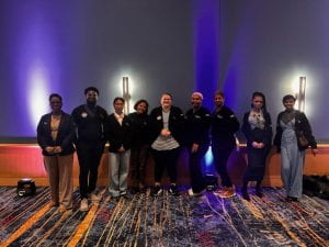 Group of attendees standing in a line, posing for a photo at MLK event