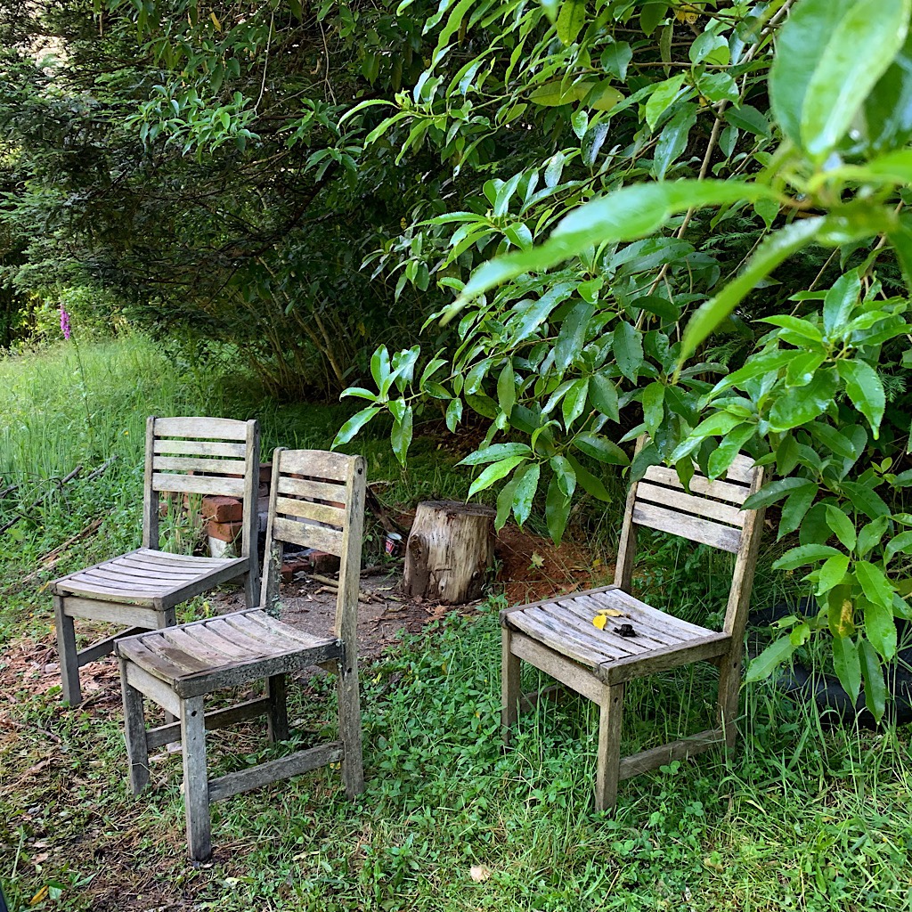 Chairs awaiting campers at a bend in the river.