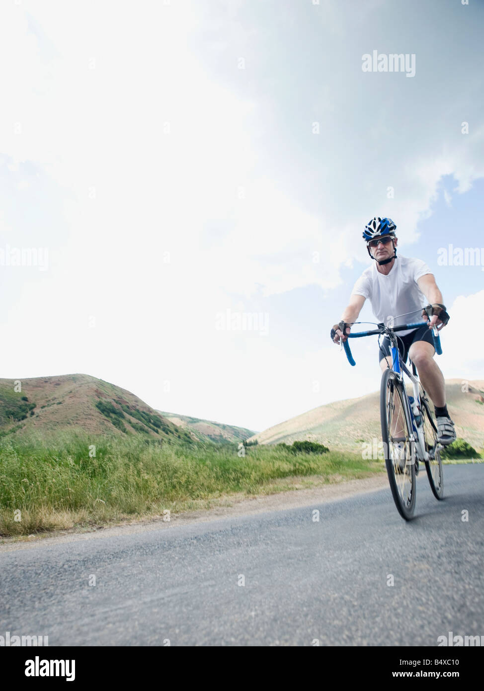 Cyclist on country road Stock Photo