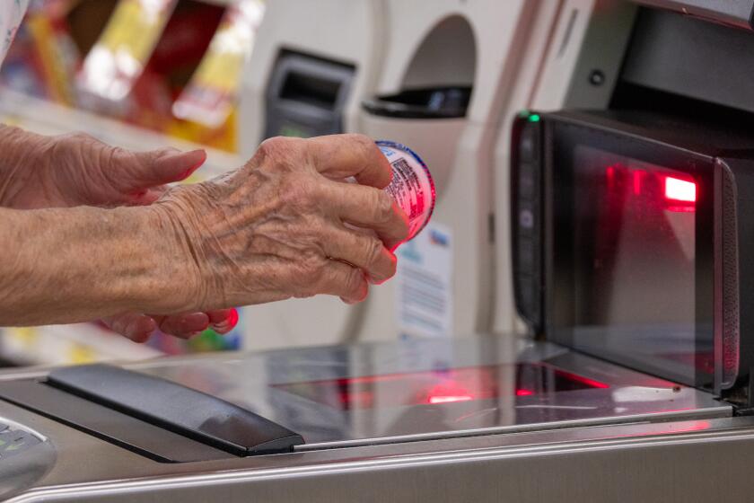 ARCADIA, CA - JULY 28: Elaine Ingram, 85, to avoid line uses self-checkout, shopping on Friday, July 28, 2023 at Albertsons in Arcadia, CA. (Irfan Khan / Los Angeles Times)