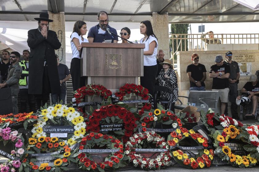 Jonathan Polin and Rachel Goldberg, parents, and sisters Orly and Leebie of killed US-Israeli hostage Hersh Goldberg-Polin whose body was recovered with five other hostages in Gaza, speak during the funeral in Jerusalem, Monday, Sept. 2, 2024. (Gil Cohen-Magen/Pool via AP)