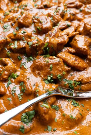 Butter Chicken (Murgh Makhani) with silver spoon