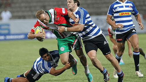 Rugby players tackling each other on the field