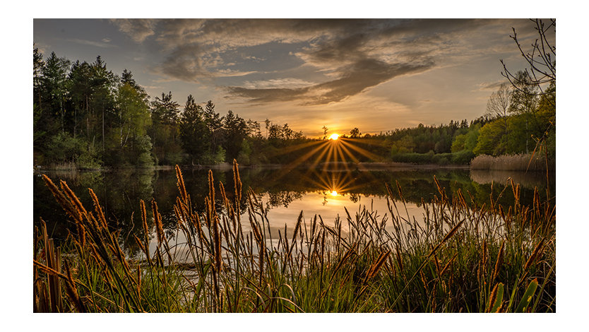 Scenic view of lake against sky during sunset.