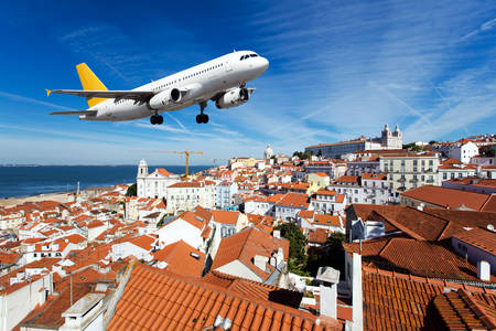 Airplane over the rooftops of the city