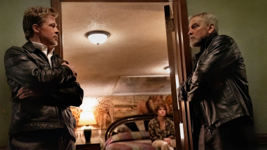 George Clooney and Brad Pitt stand in a doorway