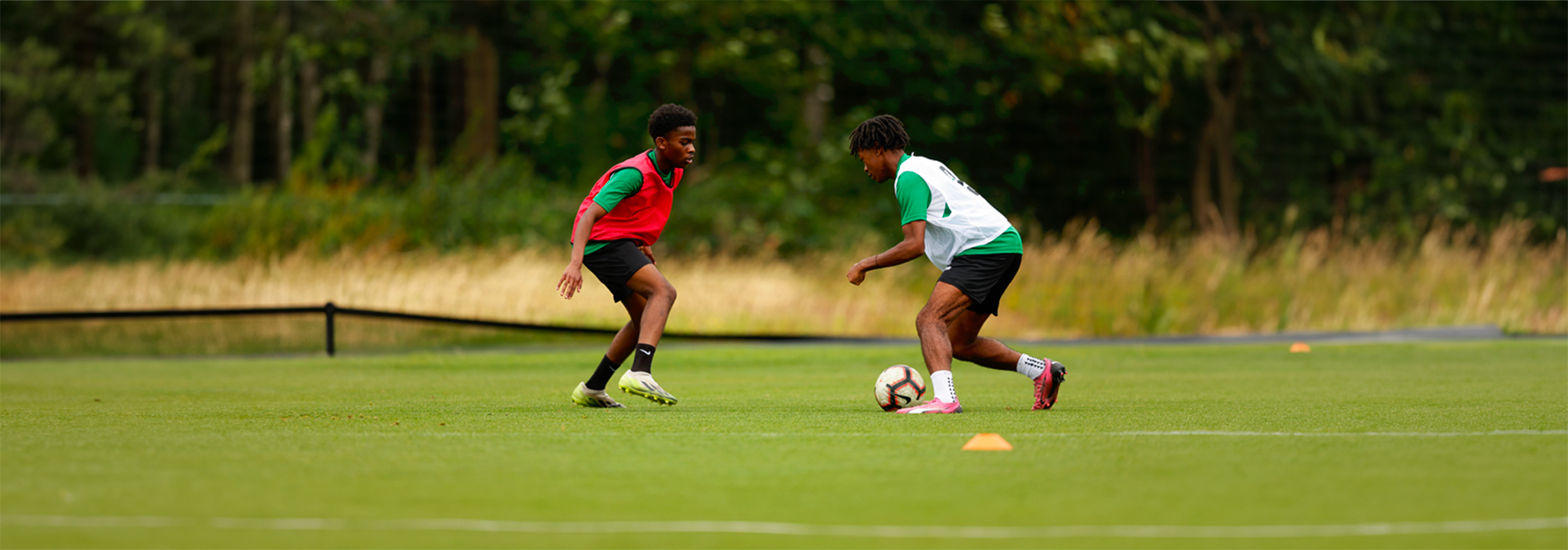 A player looks to dribble past another player.