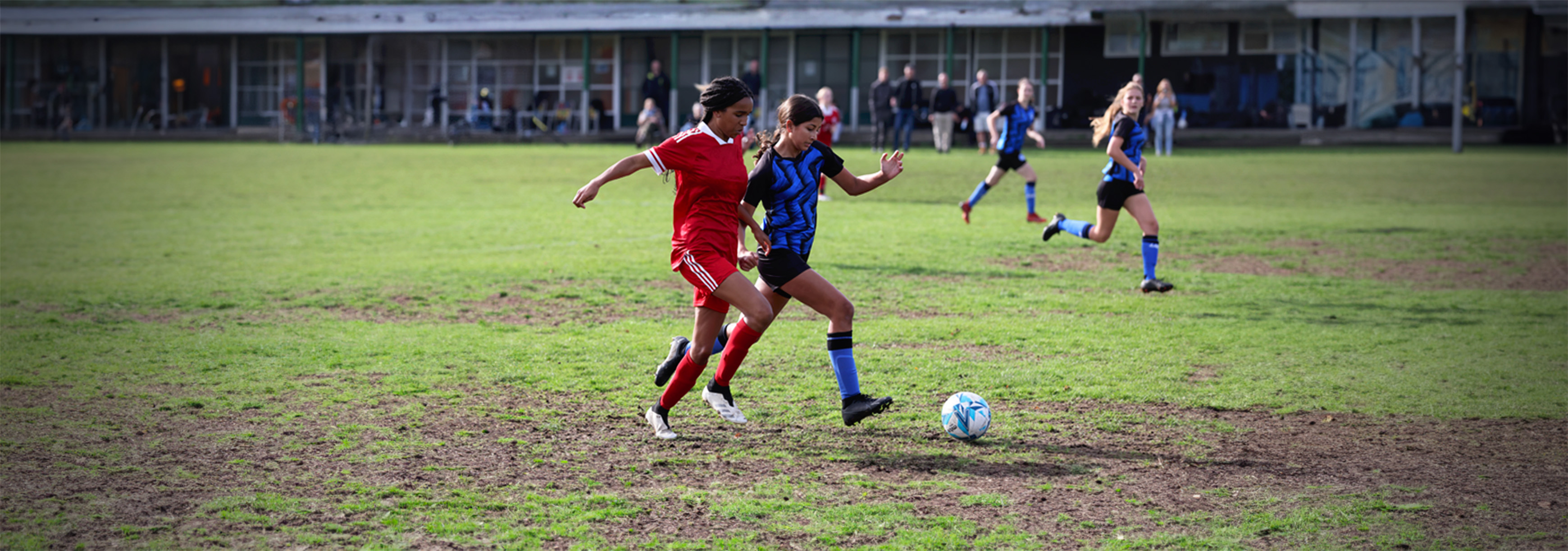 A player chases another player moving with the ball.