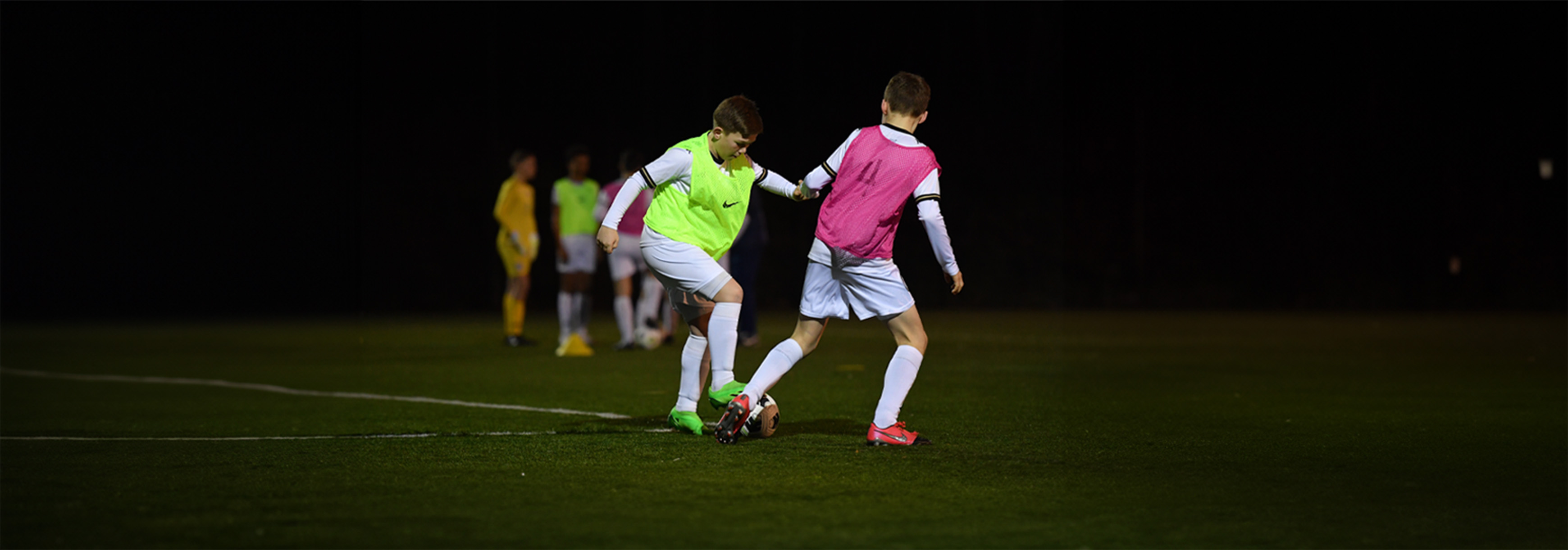 A player looks to dribble past the opposition.