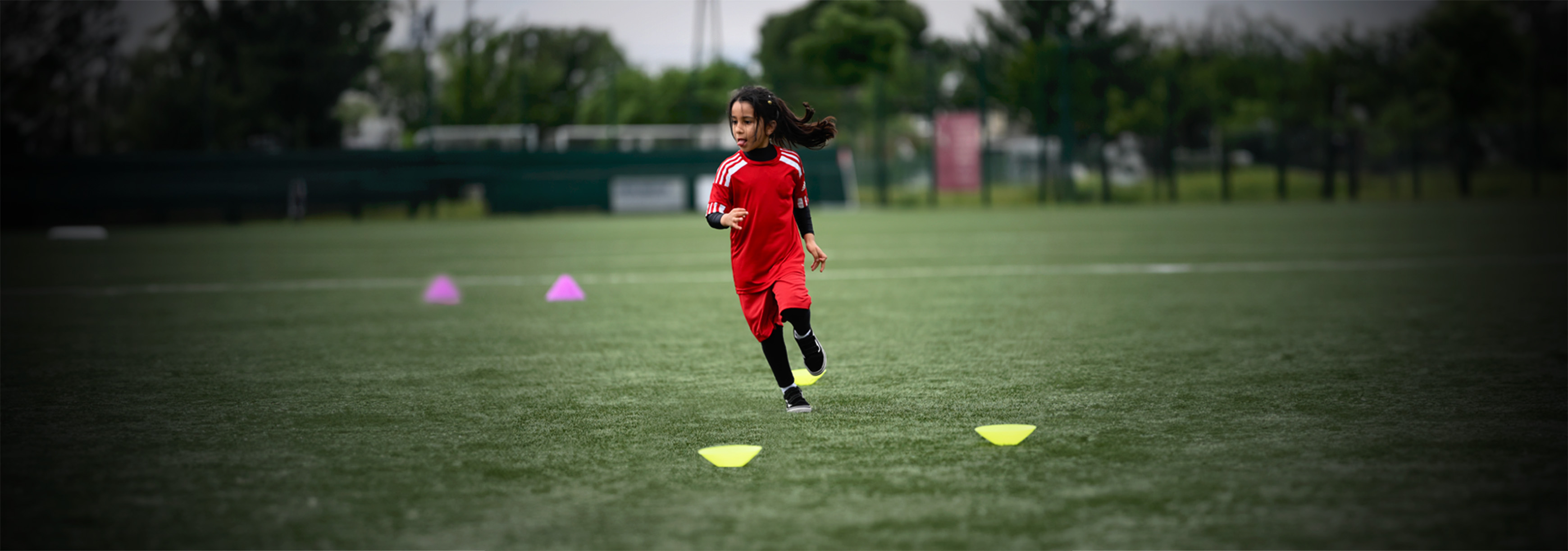 A player runs between some cones.