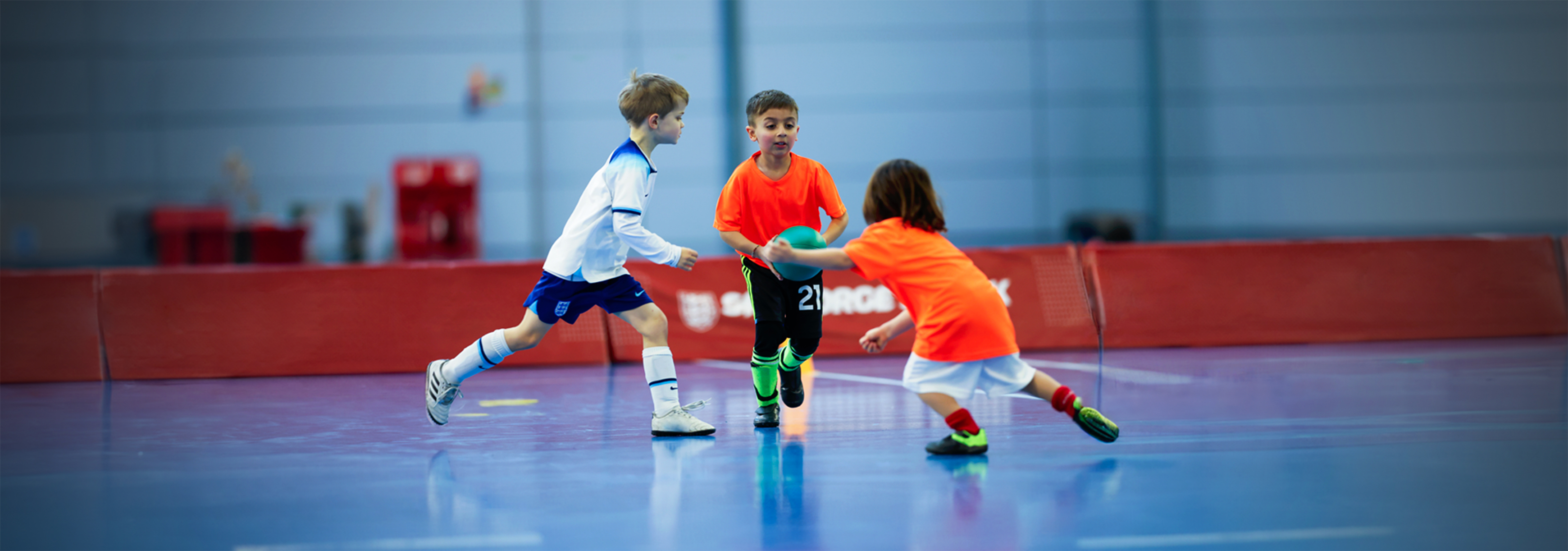 A player runs with the ball in his hands trying to avoid being tagged by an opponent.