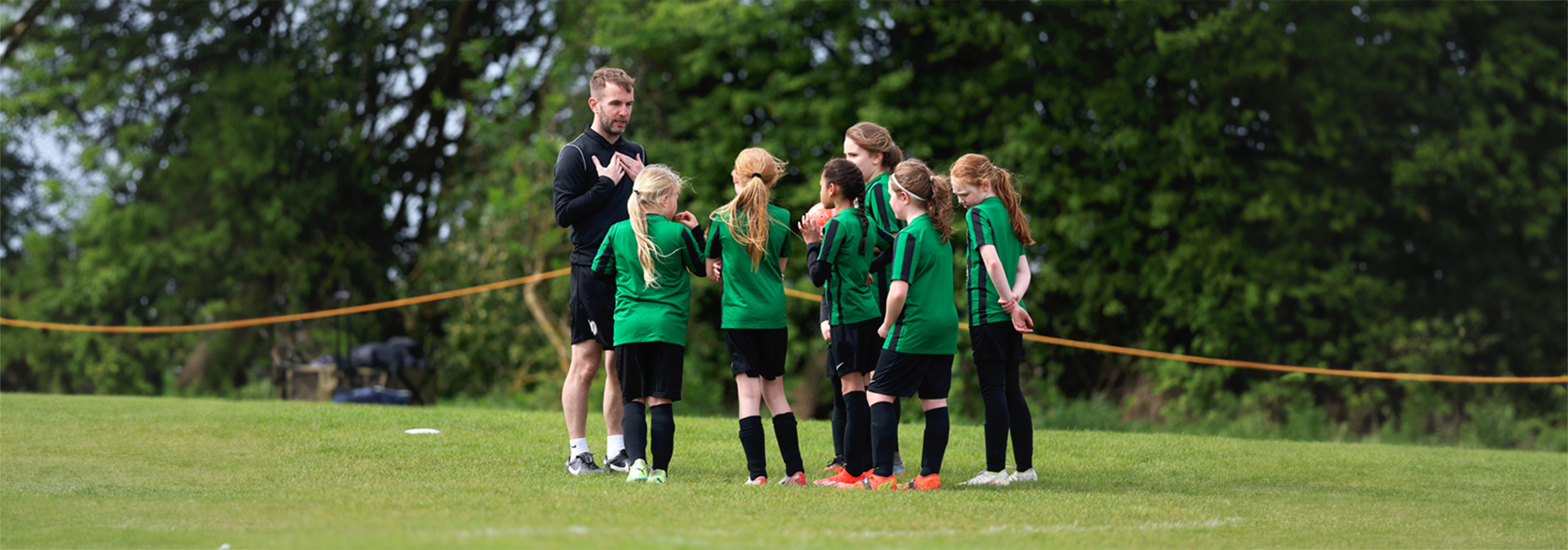 Coach talks to a group of players.