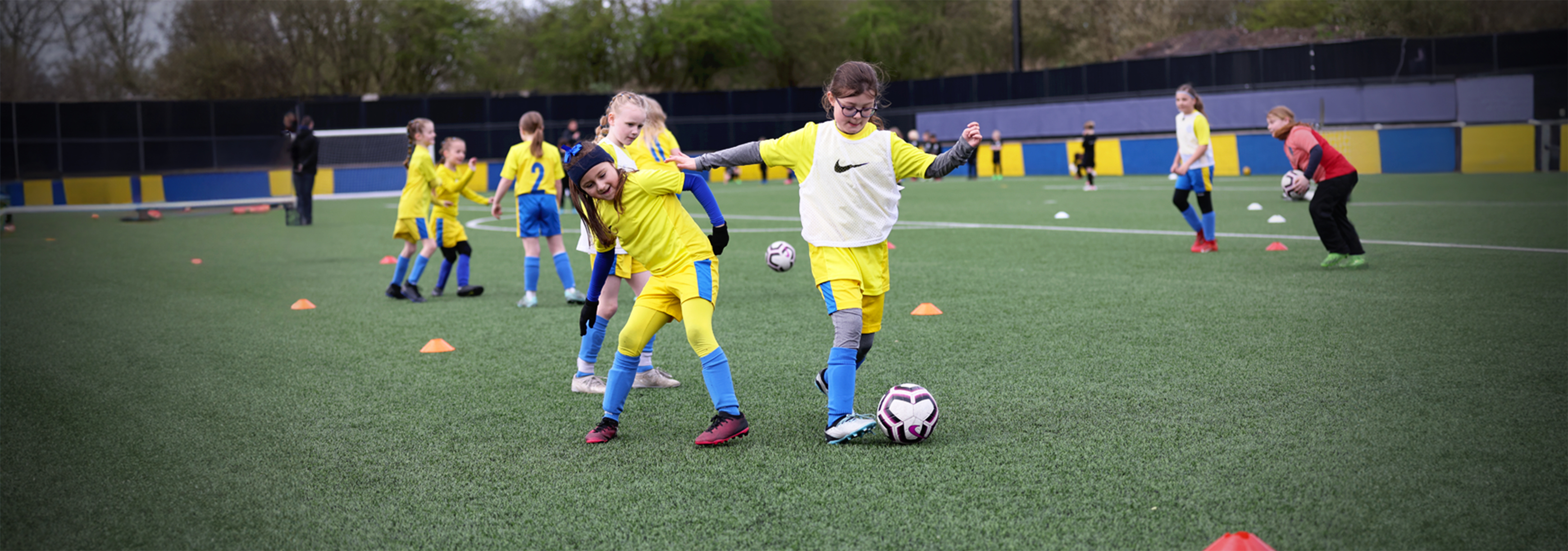 A player dribbles past her opponent during a small-sided game in training.