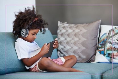 Kid on sofa with tablet