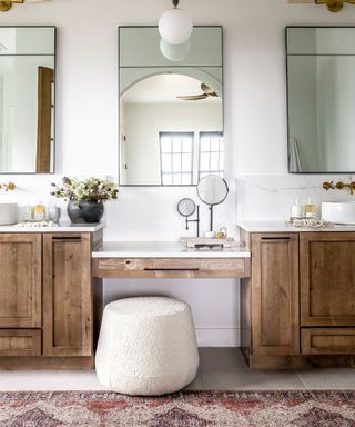 vanity in wood with boucle stool and rug