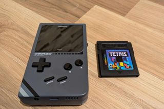 Modretro Chromatic review; a Game Boy like retro console on a wooden floor