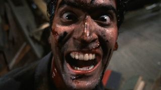 Bruce Campbell as Ash Williams laughing with his face covered in blood during Evil Dead 2.