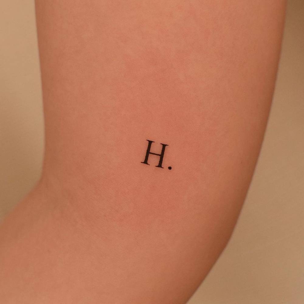 Letter "H" tattooed on the inner arm