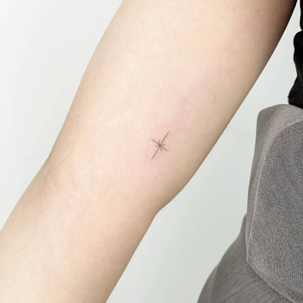 Minimalistic north star tattoo located on the inner arm.