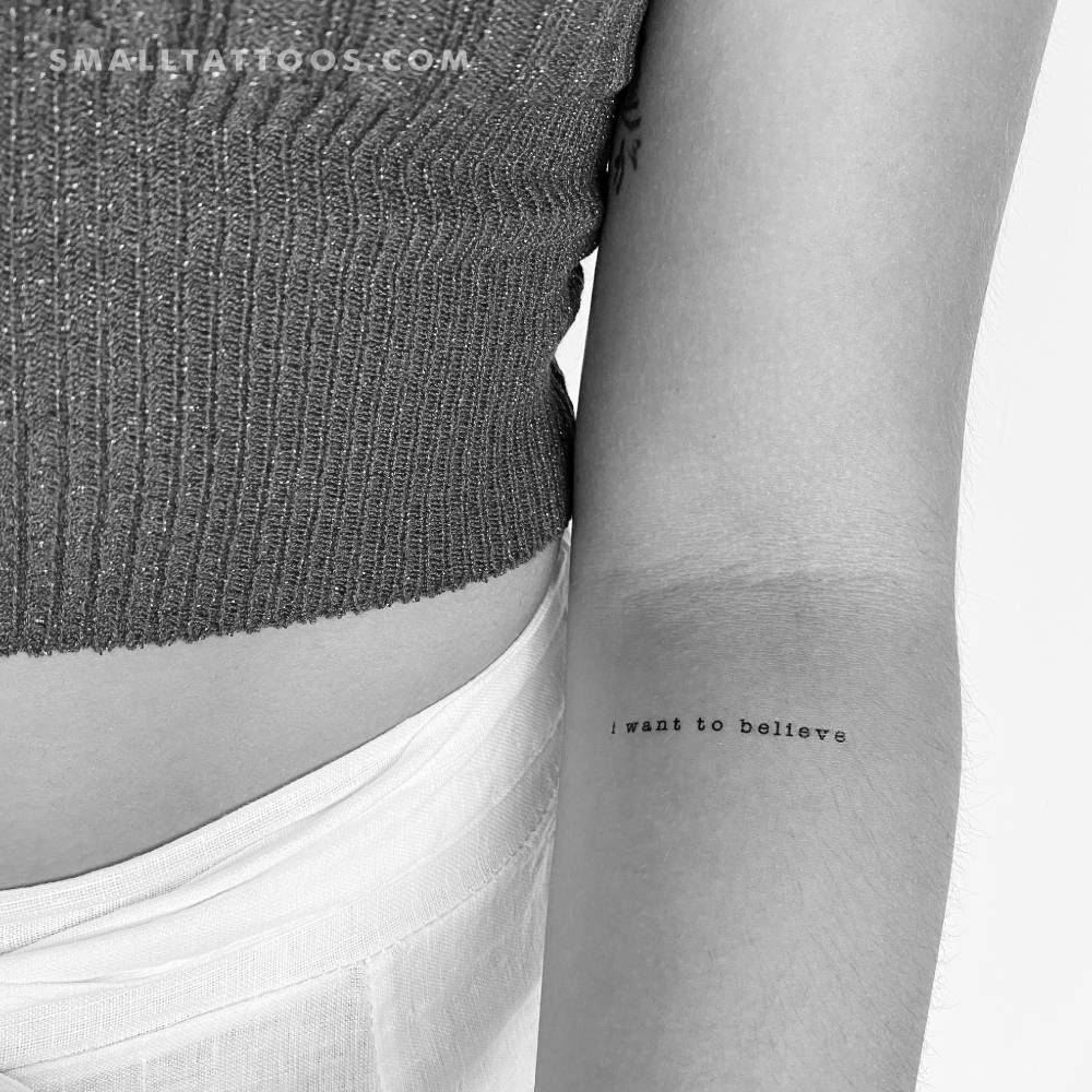 "I Want To Believe" temporary lettering tattoo placed on the inner forearm.